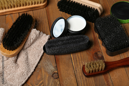 Shoe cleaning tools on wooden background photo