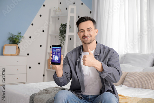 Young man holding mobile ph...