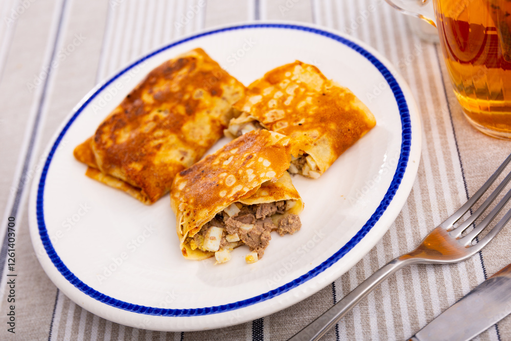 Delicious pancakes stuffed with liver and egg served on platter for breakfast Delicious pancakes stuffed with liver and egg served on platter for breakfast