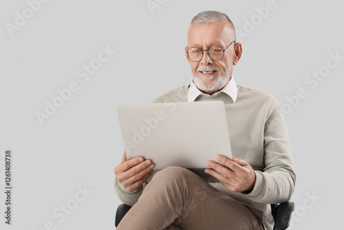 Senior businessman with lap...
