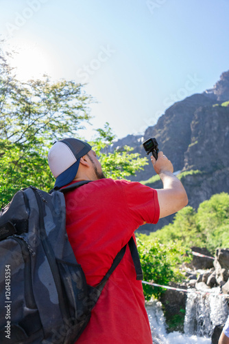 traveler creating travel content in the mountains surrounded by trees