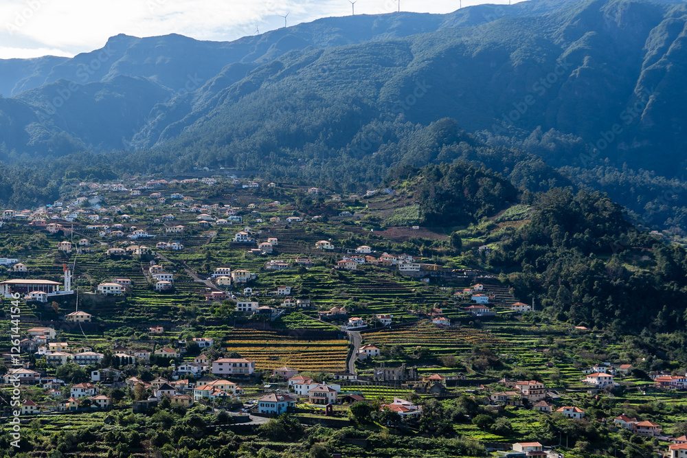 Obraz premium Mountain landscape with a valley and the town São Vicente in the distance.