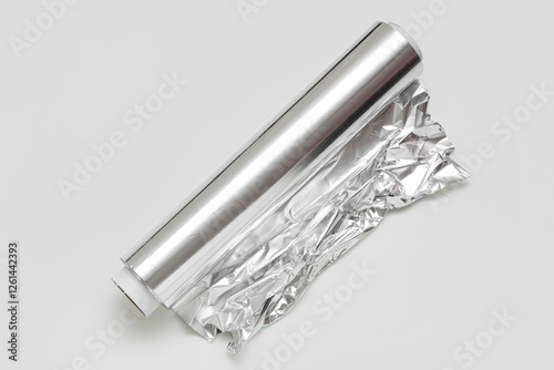 Roll of aluminium foil on white background