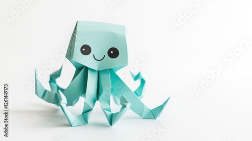 A cute paper origami octopus with a smiling face and extended tentacles. photo