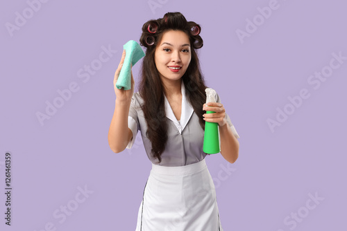 Young Asian chambermaid wit...