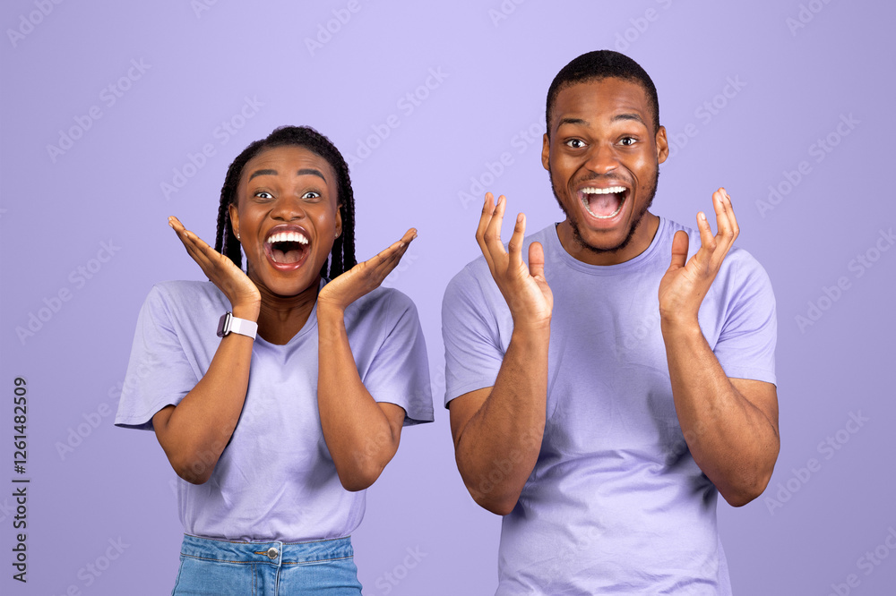Wow. Portrait of overjoyed young black man and woman with open mouth gesturing in amazement looking at camera. Emotional surprised couple posing standing isolated over purple studio background wall Wow. Portrait of overjoyed young black man and woman with open mouth gesturing in amazement looking at camera. Emotional surprised couple posing standing isolated over purple studio background wall