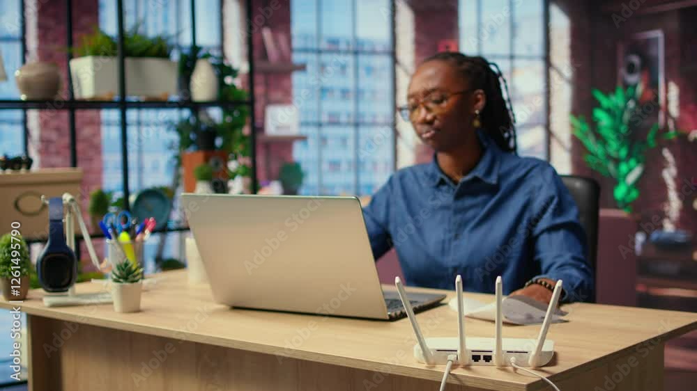 Irritated African American girl struggling to reach the internet provider to help fix the signal loss issues, freelancer working at home with an unstable Wi Fi connection. Camera A.