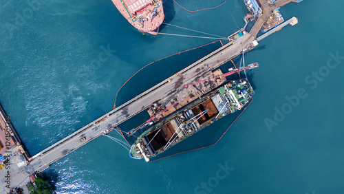 Oil tanker ship at dry dock concept maintenance service. working at dry dock. Insurance and Maintenance Crude tanker Ship concept. Freight Forwarding Service maintenance Insurance. photo