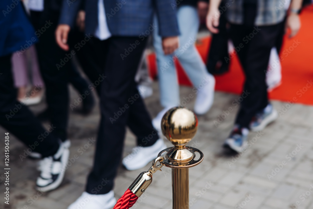 Naklejka premium Red carpet with ropes and golden barriers on a luxury party entrance, cinema premiere tv film festival event award gala ceremony, wealthy rich guests arriving, outdoor decoration elements, summer day