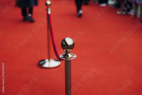 Red carpet with ropes and golden barriers on a luxury party entrance, cinema premiere tv film festival event award gala ceremony, wealthy rich guests arriving, outdoor decoration elements, summer day
