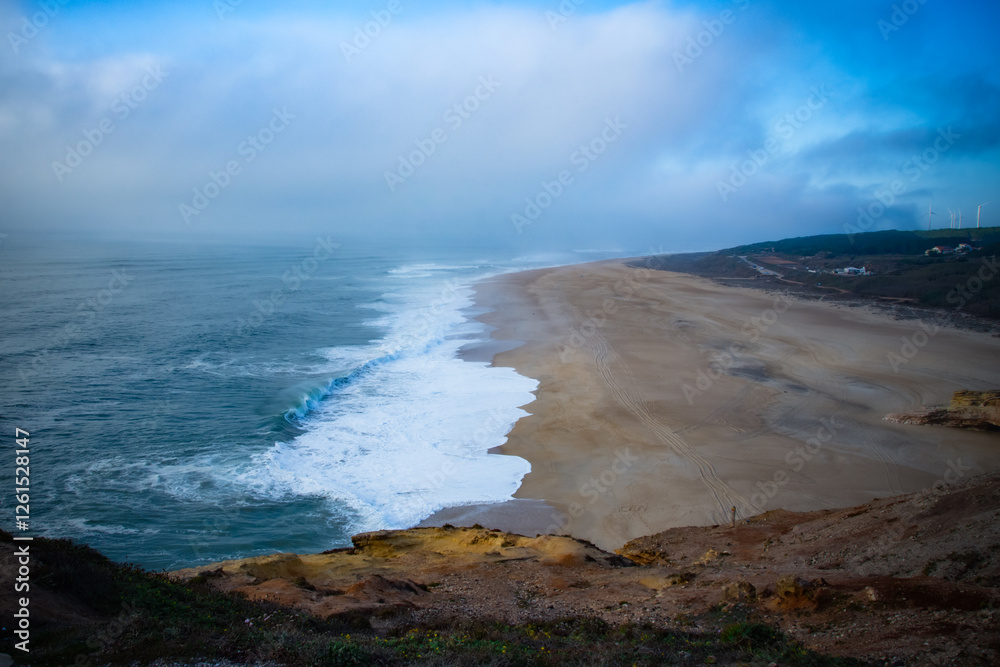 A serene coastal beach view with gentle waves and a soft blue sky. A serene coastal beach view with gentle waves and a soft blue sky.