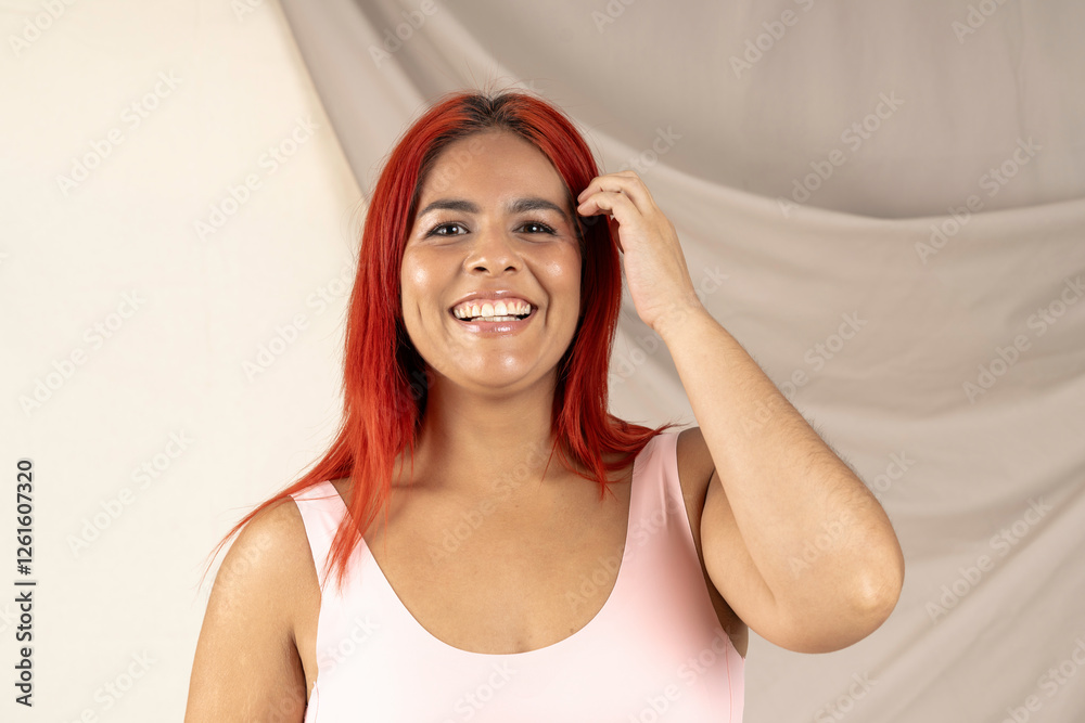 Happy redhead woman touching her hair and smiling Happy redhead woman touching her hair and smiling