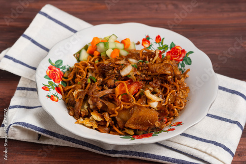 Mie Jawa or Bakmie Jawa, Javanese traditional noodle. Served on plate, Close up. Perfect for recipe, article, catalogue, or any commercial purposes. with copy space.