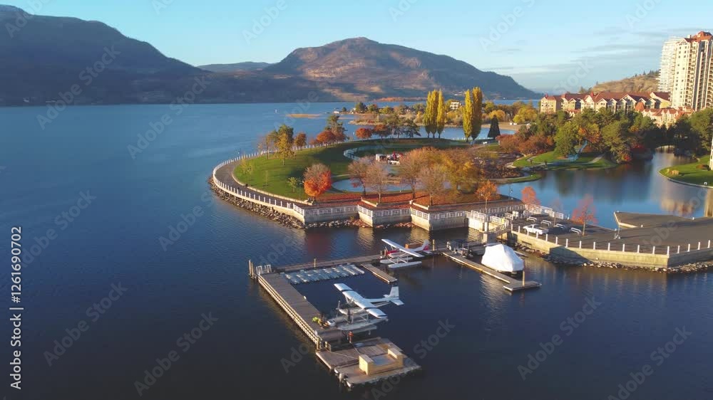 Downtown Waterfront, Kelowna, BC, Canada. Panorama Calm Okanagan Lake Landscape. British Columbia Interior in the Fall Autumn Season with Colourful Trees. Evening Sunset, City Park Walking Path