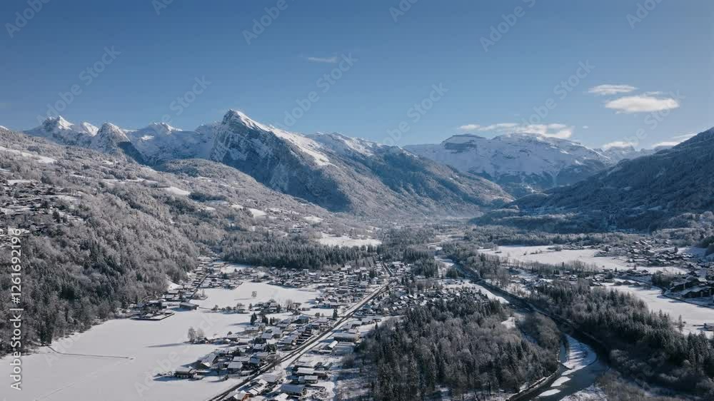 Mountainous snow-covered landscape with a river winding through the valley