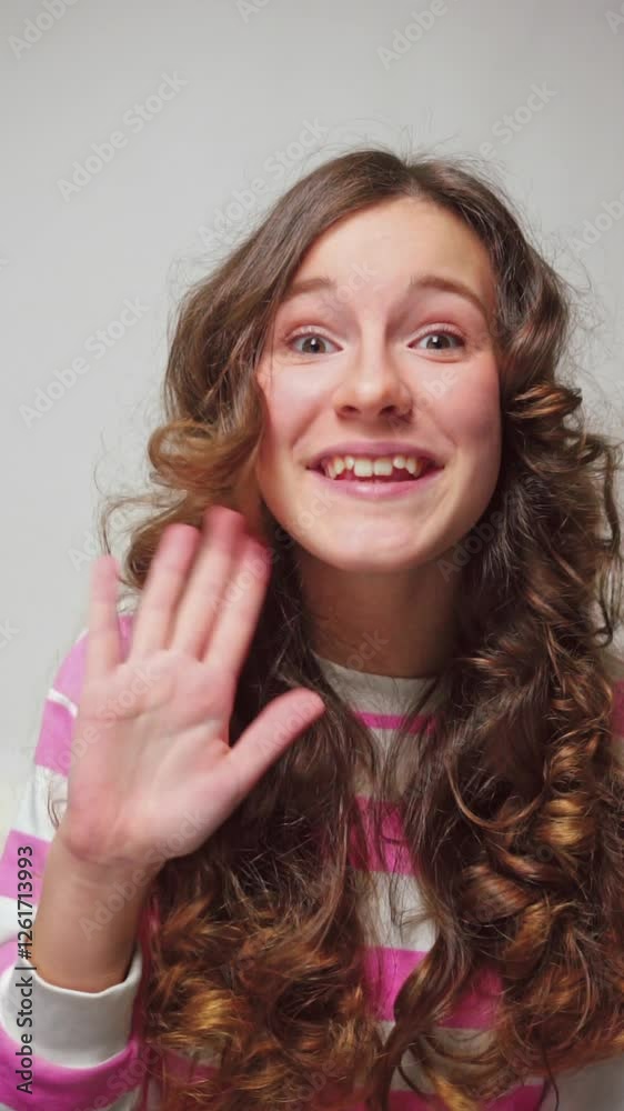 Vertical video little girl happily waving hello Vertical video little girl happily waving hello
