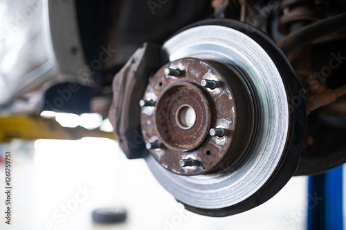 Disc Brake Close-Up: A detailed close-up of a disc brake rotor and caliper, showcasing the intricate engineering and functionality of this essential automotive component. photo