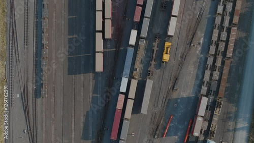 High-angle view of a rail yard. Many freight cars and trains are parked on tracks. Logistics and transportation. PENROSE, AUCKLAND, NZ photo
