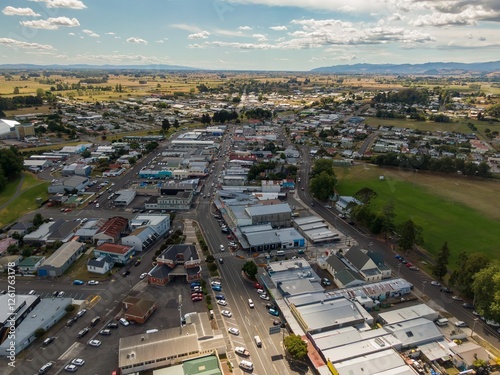 High-angle view of Paeroa town center, showing streets, buildings, and a park. Cars are visible on the roads. A sense of community and daily life. Downtown, Paeroa, Waikato, New Zealand photo
