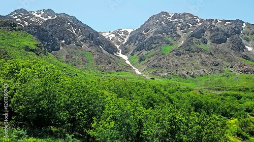 Majestic mountains with lush green valleys and snow-capped peaks under a clear blue sky.
📍Hawraman Takht - Kurdistan photo