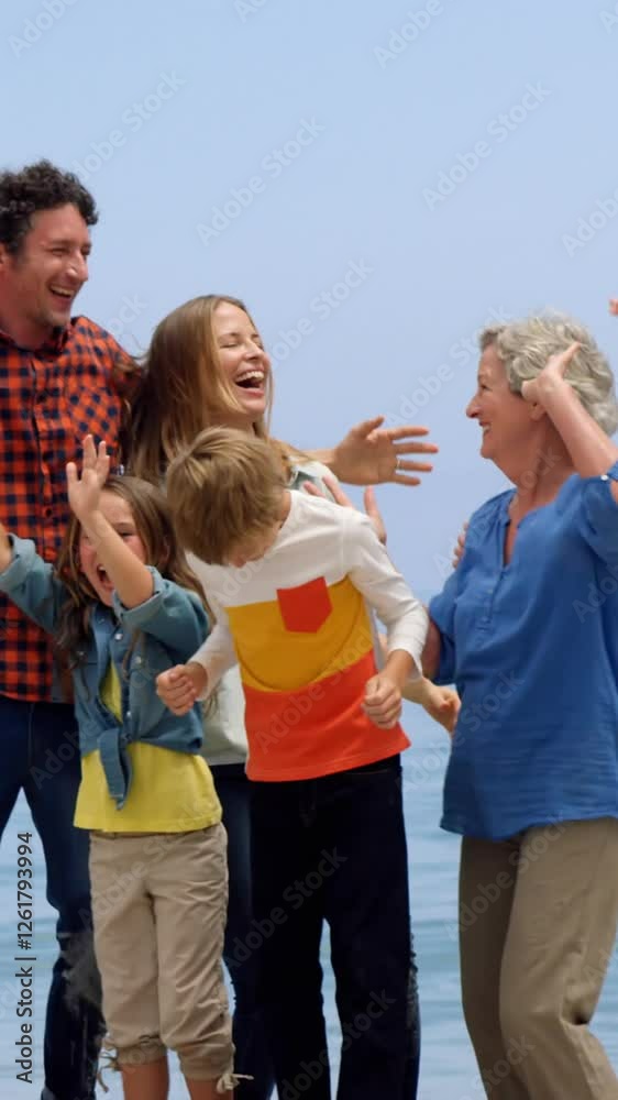 Multi generation family jumping on the beach Multi generation family jumping on the beach