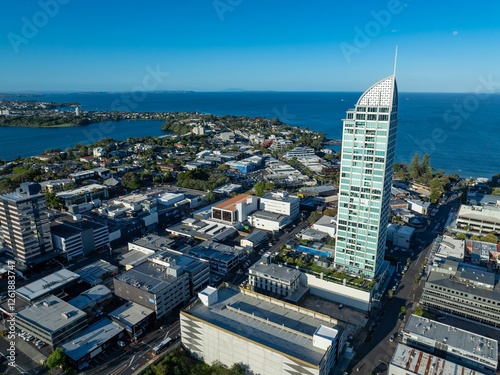 High-angle view of Auckland city, New Zealand, showcasing modern architecture and waterfront. Urban sprawl meets harbor. TAKAPUNA, AUCKLAND, NZ photo