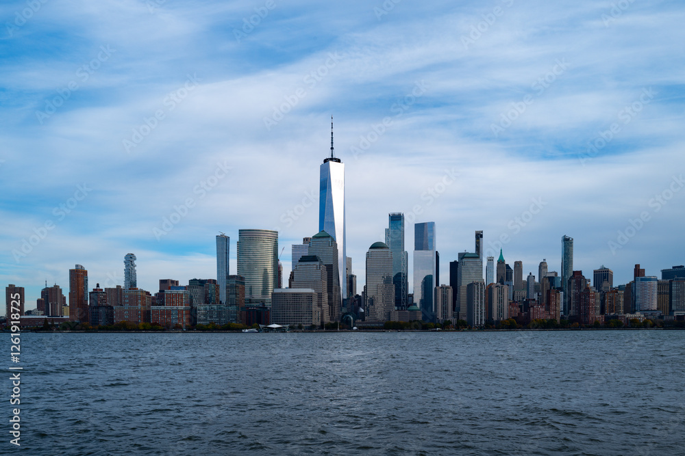 Obraz premium New York City cloudy skyline. NYC skyscrapers. Manhattan. NY cityscape with clouds. Downtown New York buildings. NYC skyline. New York harbor view. Skyscrapers in Manhattan. NYC downtown.