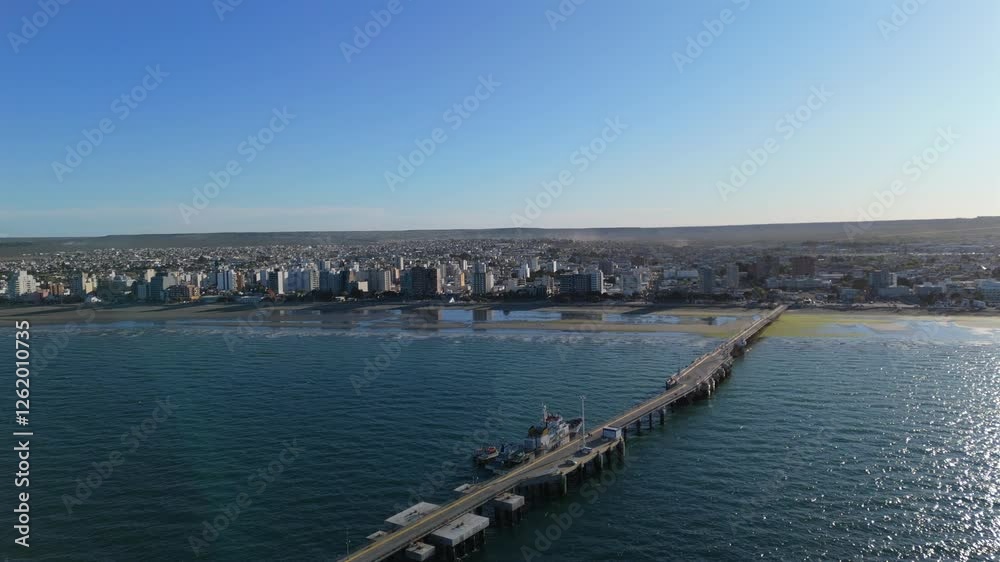 Puerto Madryn bay and pier on Argentina’s Atlantic coast. The scenic view showcases calm waters, vibrant waterfront, and the iconic pier set against a beautiful coastal landscape. Puerto Madryn bay and pier on Argentina’s Atlantic coast. The scenic view showcases calm waters, vibrant waterfront, and the iconic pier set against a beautiful coastal landscape.