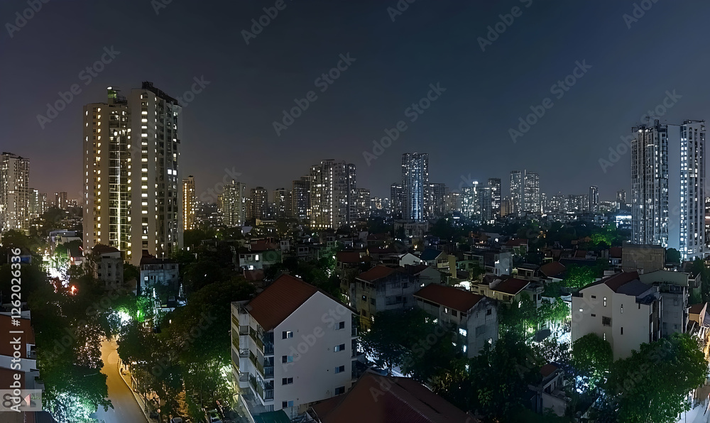Fototapeta premium Night cityscape panorama showcasing a blend of modern high-rises and traditional low-rise buildings, illuminated streets, and lush greenery.