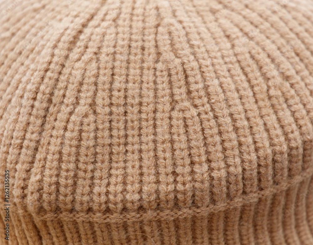 A close up of a knit hat with a tan color A close up of a knit hat with a tan color