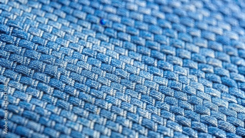 Close-up view of a detailed blue woven textile texture with an intricate pattern of interwoven threads