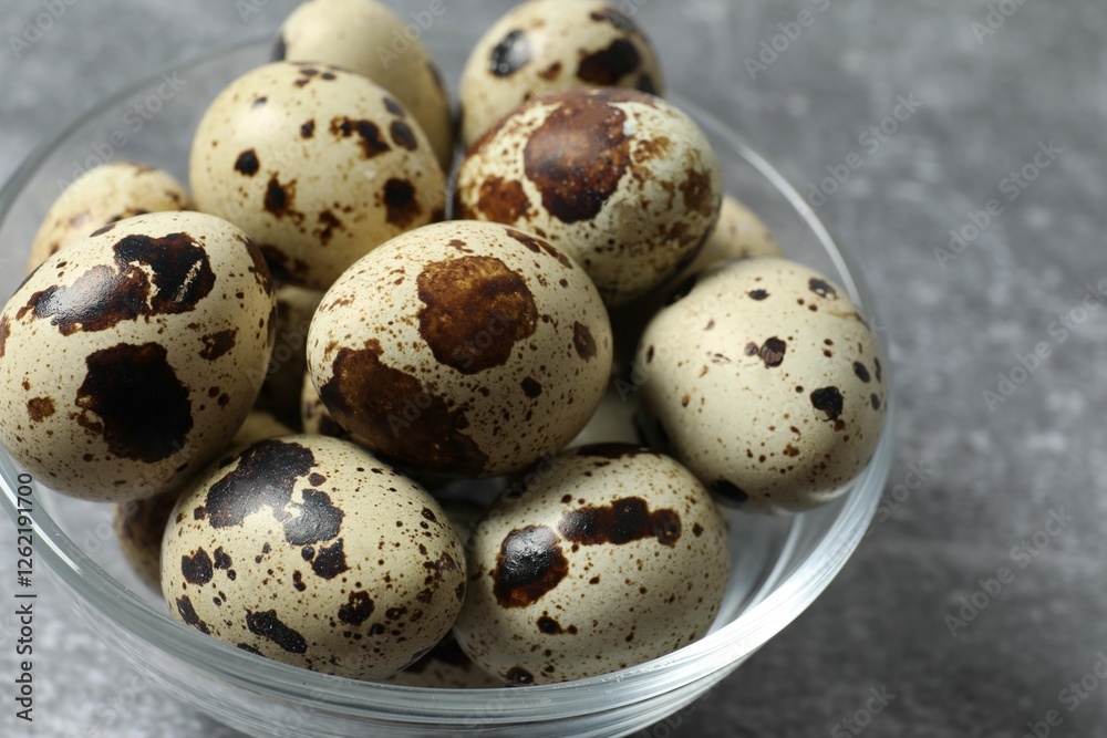 Quail eggs in a plate on gray background Quail eggs in a plate on gray background