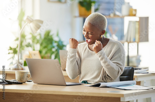 Business, laptop and black woman in office, celebration and excited with funding approval for charity. NPO, employee and African person in workplace, computer and cheering with email for donations