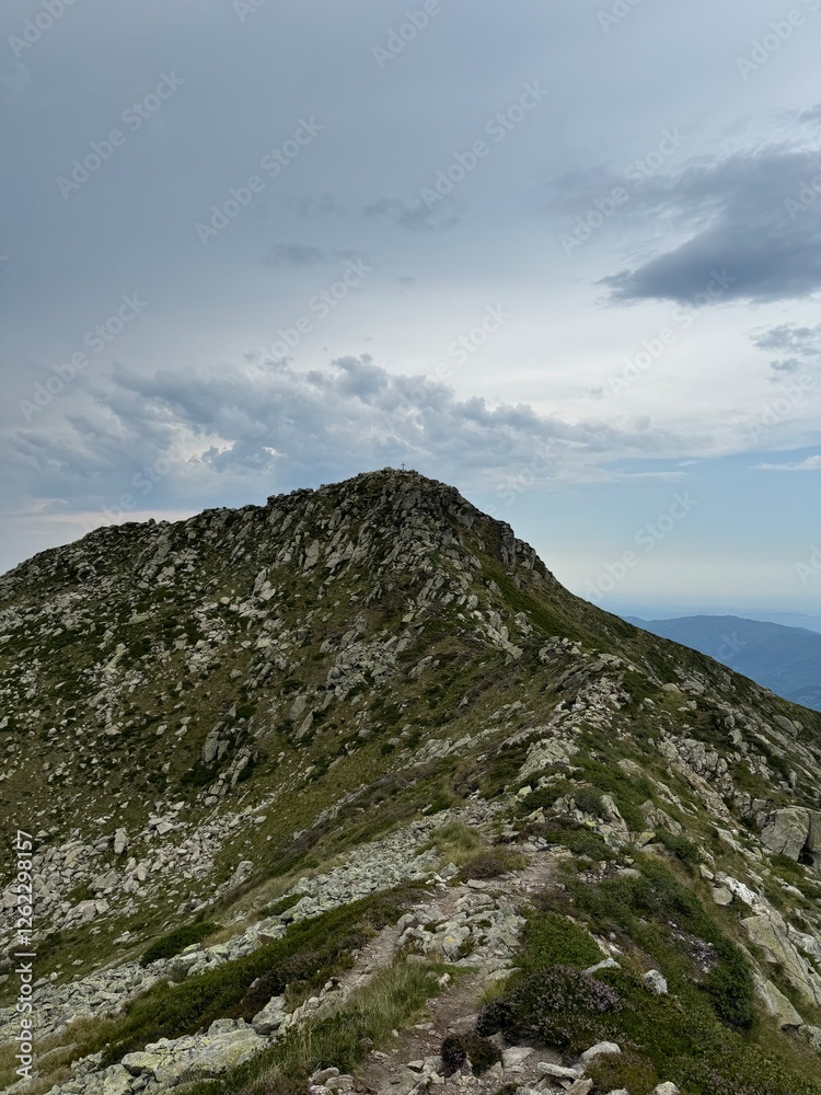 view of a mountain landscape with clouds from a peek view of a mountain landscape with clouds from a peek