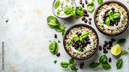 A clean arrangement of cooked quinoa, black beans, and Greek yogurt in individual bowls. photo