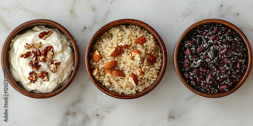 A clean arrangement of cooked quinoa, black beans, and Greek yogurt in individual bowls. photo