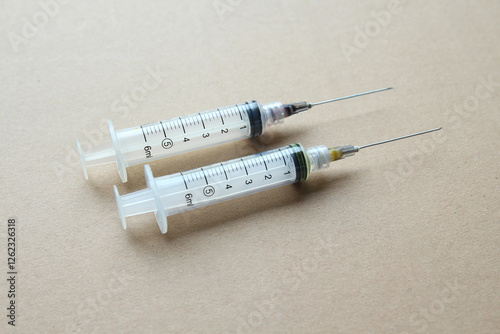 syringe needle studio shot on blue background. closup of medical equpment for healthcare treatment service likes injection, vaccination, liquid measurement on larboratory or clinic