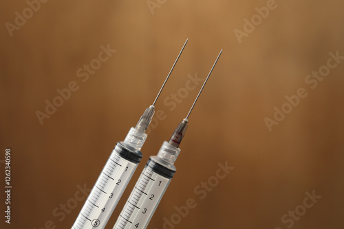 syringe needle studio shot on blue background. closup of medical equpment for healthcare treatment service likes injection, vaccination, liquid measurement on larboratory or clinic