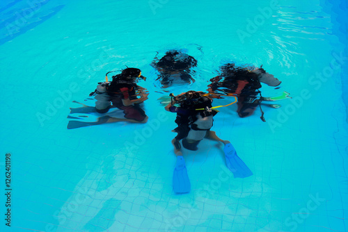 Group of scuba diver training session in a swimming pool.