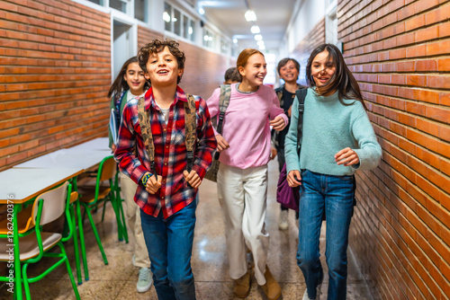 Group of students running in school hallway