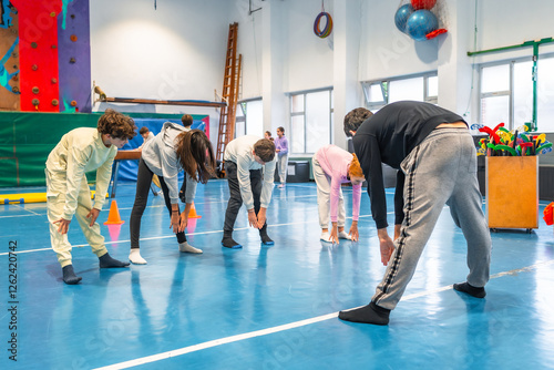 Photography High school students stretching in gym class during physical education lesson