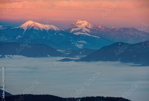 Mountain peak at sunset sunlight. Dramatic sunset with the sun setting behind mountain peaks, casting long shadows across the landscape. Mala Fatra Slovakia. photo