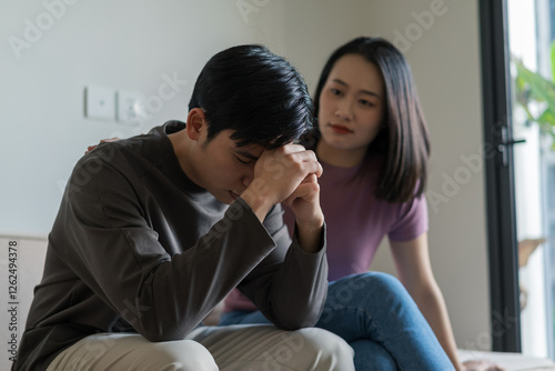Asian wife comforts depressed husband
