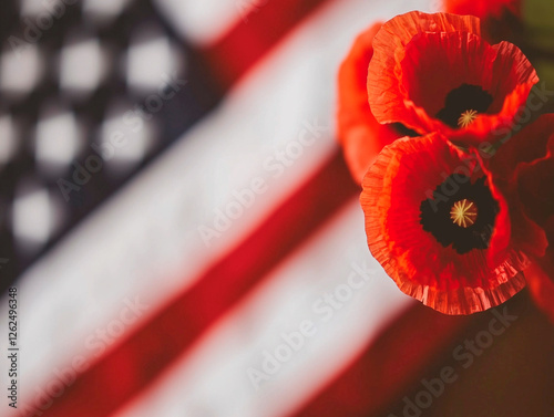 A red poppy flower is in front of an American flag