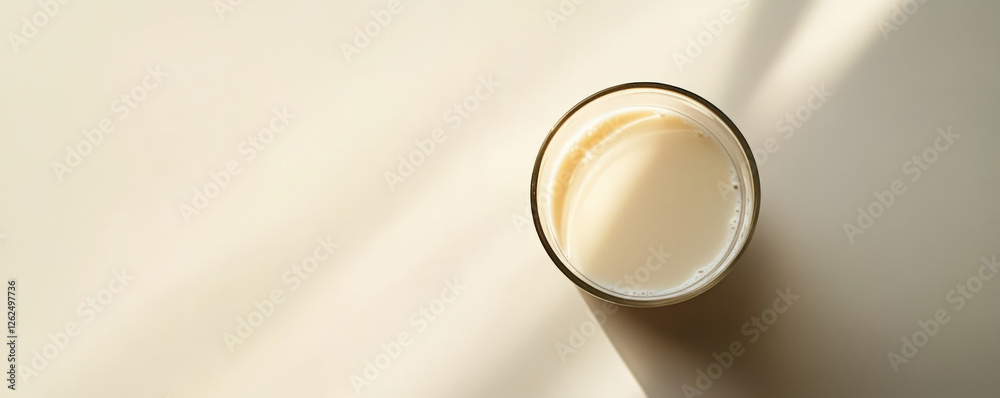 clean glass of soy milk sits on light surface, casting soft shadows. minimalist composition highlights smooth texture and creamy color of drink, evoking sense of calm and simplicity clean glass of soy milk sits on light surface, casting soft shadows. minimalist composition highlights smooth texture and creamy color of drink, evoking sense of calm and simplicity