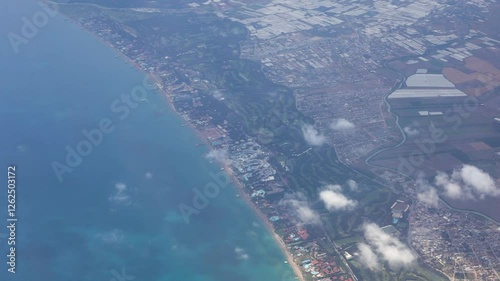 The view from the airplane of the Mediterranean coastline with resorts and beaches.