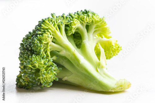 Broccoli, placed on white surface. Nutritional qualities and recipes.