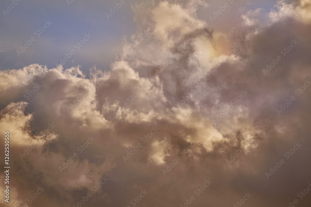 A sky filled with sunlight and clouds painted in warm tones. Pristine white clouds take on golden and pink hues under the sun's rays, creating an atmosphere of tranquility and serenity. A sky filled with sunlight and clouds painted in warm tones. Pristine white clouds take on golden and pink hues under the sun's rays, creating an atmosphere of tranquility and serenity.