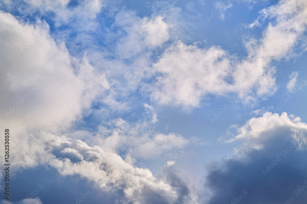 White cumulus clouds majestically float in the blue sky, illuminated by bright sunlight. Their soft shapes create an atmosphere of lightness and tranquility. White cumulus clouds majestically float in the blue sky, illuminated by bright sunlight. Their soft shapes create an atmosphere of lightness and tranquility.