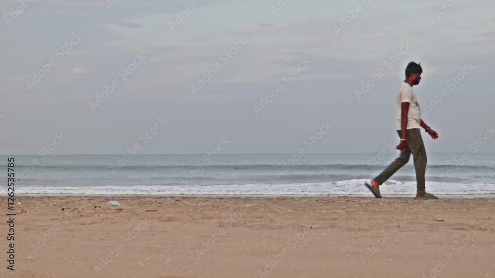 Indian person walking in gandhi beach or marina beach at Triplicane, Chennai, Tamil Nadu, india. sun set time, stable shot, 4k. Indian person walking in gandhi beach or marina beach at Triplicane, Chennai, Tamil Nadu, india. sun set time, stable shot, 4k.